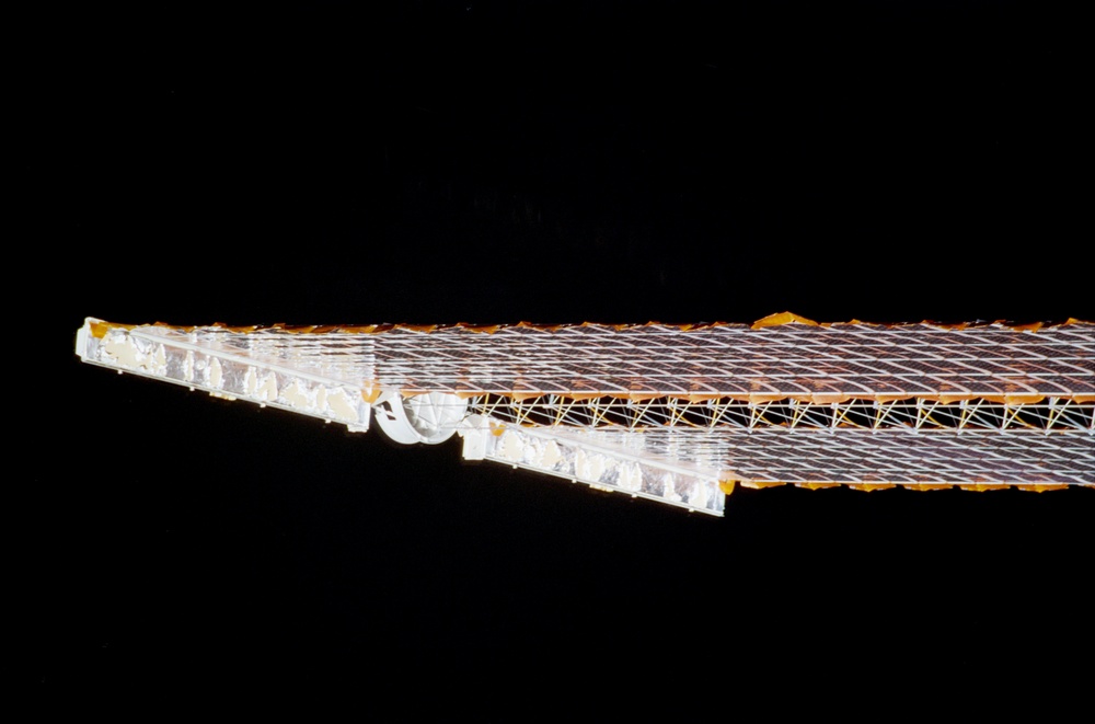View of a P6 Truss Solar Array Wing taken during the STS-108 undocking and flyaround