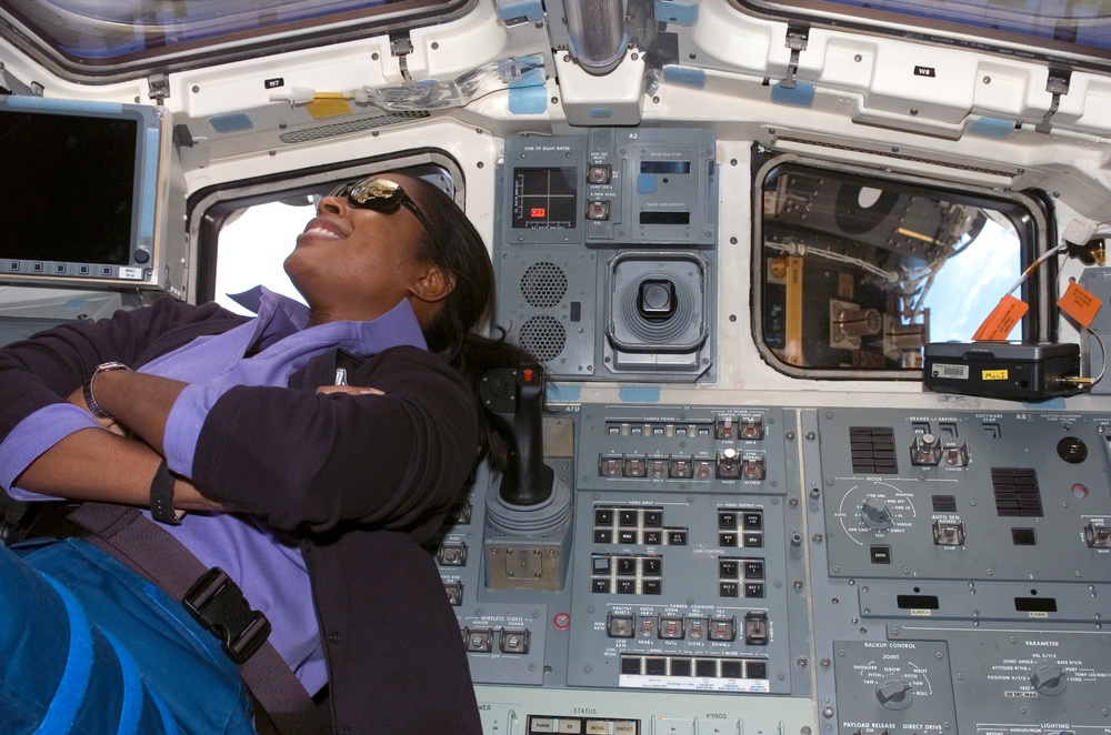 STS-116 MS Higginbotham looks out the aft FD window on Space Shuttle Discovery during Joint Operations