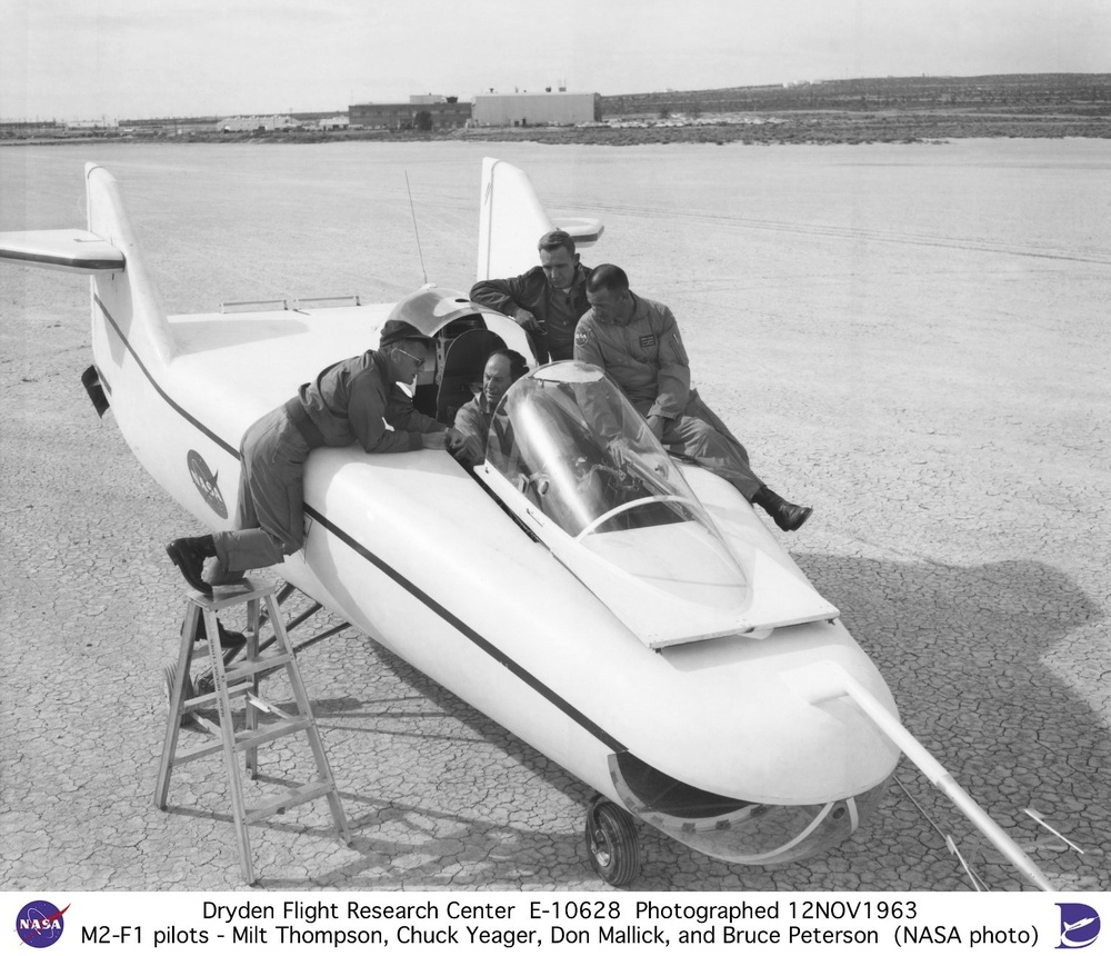 M2-F1 on lakebed with pilots Milt Thompson, Chuck Yeager, Don Mallick, and Bruce Peterson