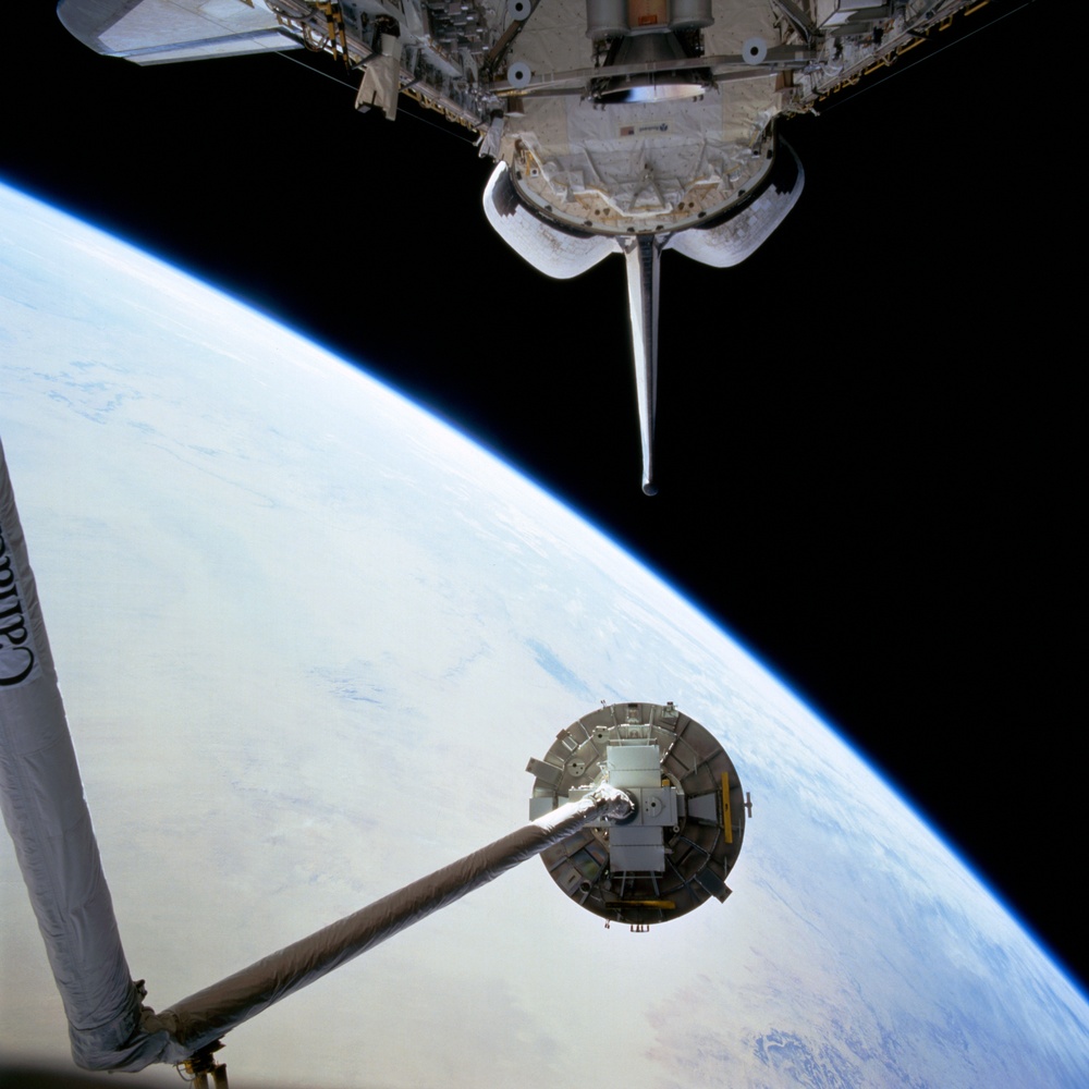 WSF, view of satellite on RMS arm during deployment procedures