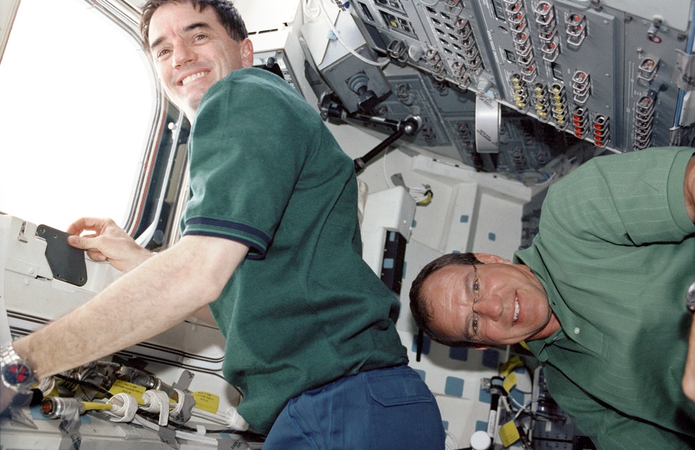 Walheim and Bloomfield pose on the aft flight deck of Atlantis during STS-110