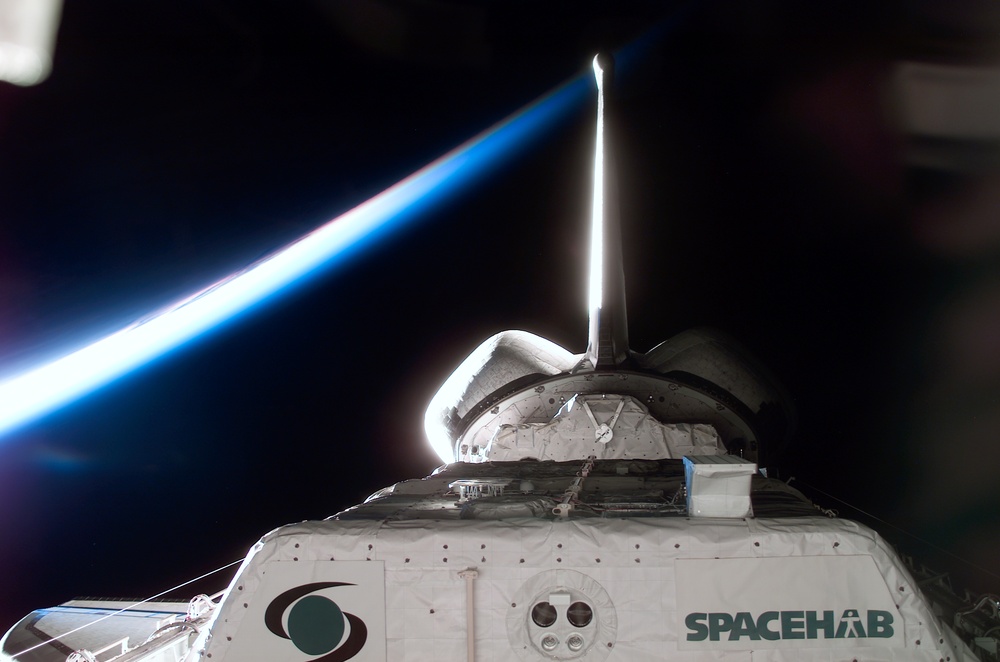 Spacehab RDM in Columbia's PLB backdropped by Earth's limb during STS-107