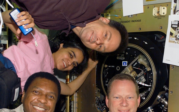 Ramon, Anderson, Chawla and Brown pose beside MIST installed in the CM-2 in the SH during STS-107
