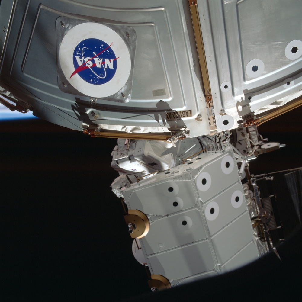 MS Parazynski works on the U.S. Laboratory during the first EVA for STS-100