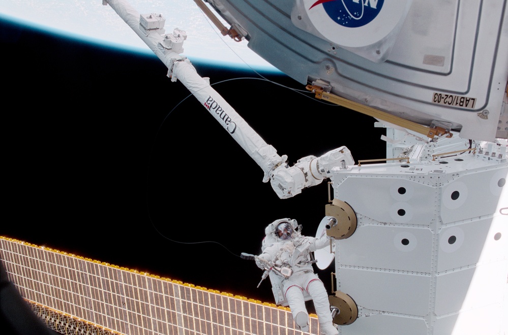 MS Hadfield works on the SLP during an EVA for STS-100