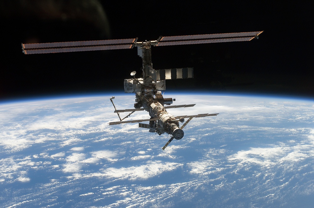 Aft - zenith view of the ISS taken during STS-110's undocking and final flyaround