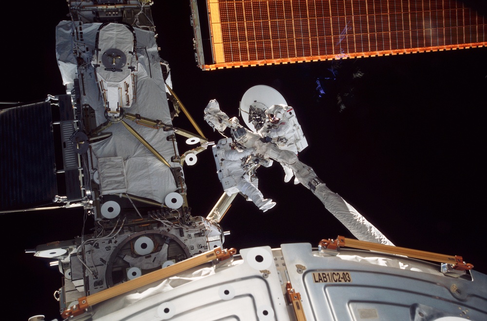 MS Godwin and MS Tani are carried by the RMS during STS-108's EVA