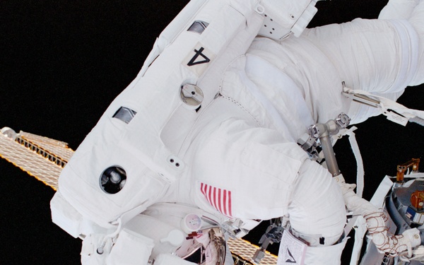 MS Parazynski drives in a bolt for the UHF antenna on Destiny during the first EVA of STS-100