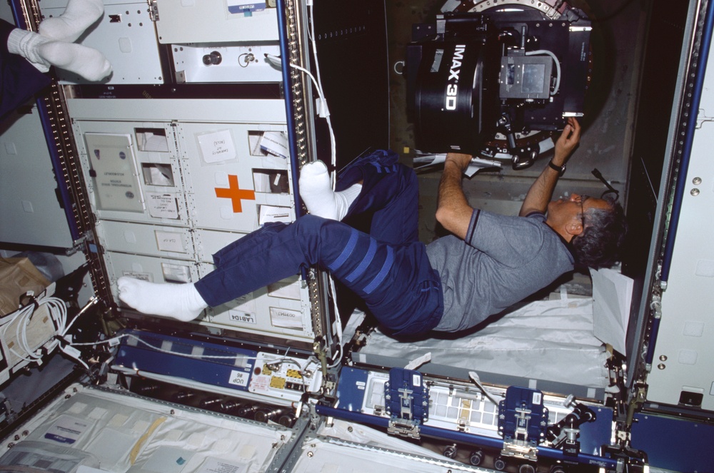 MS Phillips works on the IMAX camera in the U.S. Laboratory during STS-100