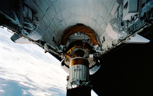 During STS-54 IUS/TDRS is released from cradle/tilt table above OV-105's PLB