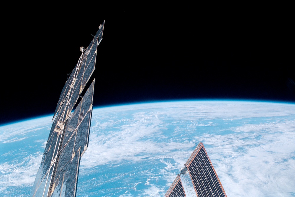 View of the Earth limb with solar arrays in the frame