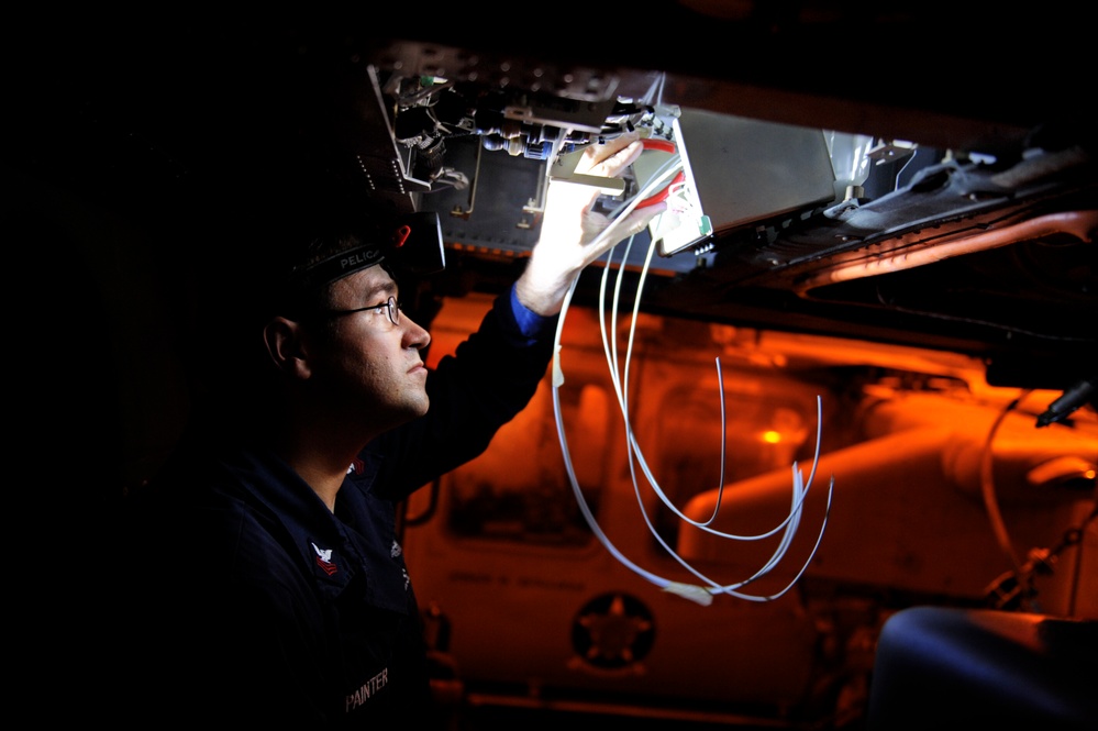 USS Nimitz crew performs aircraft maintenance