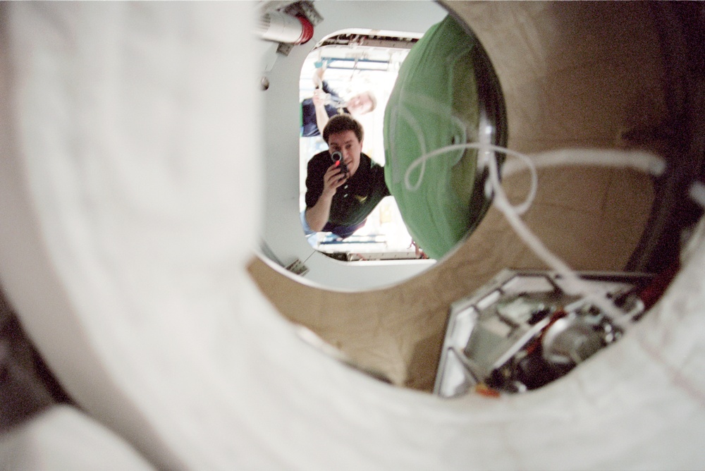 View through airlock window of Krikalev opening PMA hatch