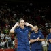 Petty Officer 2nd Class Andrew Garcia eggs on a crowd at a Houston Rockets halftime show