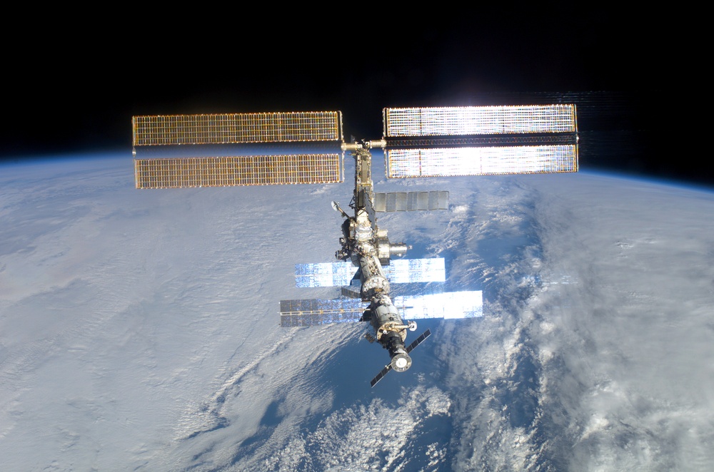 The aft - zenith side of the ISS taken during the STS-108 undocking and flyaround