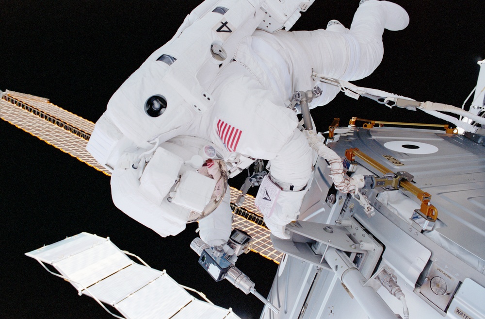 MS Parazynski drives in a bolt for the UHF antenna on Destiny during the first EVA of STS-100