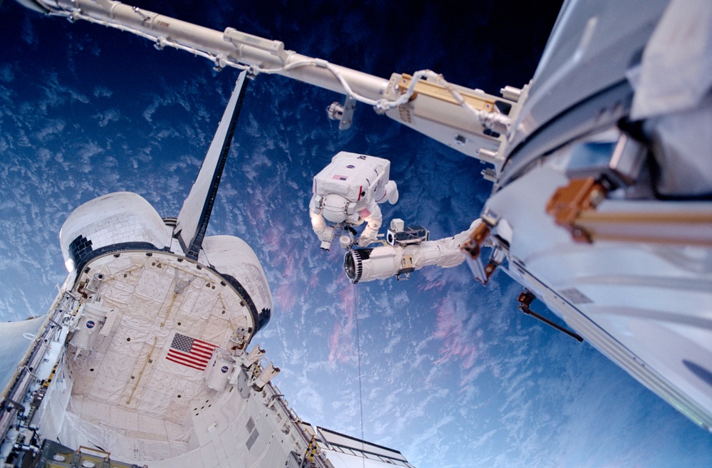 Barry on the RMS above the payload bay during EVA2