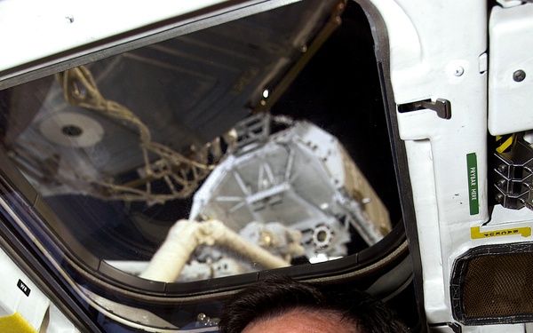 MS Hadfield works at the RMS controls on the flight deck of Endeavour during RMS handshake