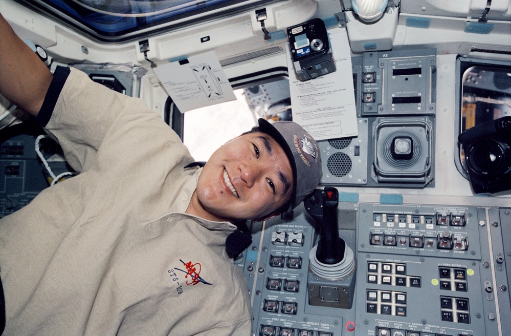 MS Tani poses with FDF's on the flight deck during STS-108