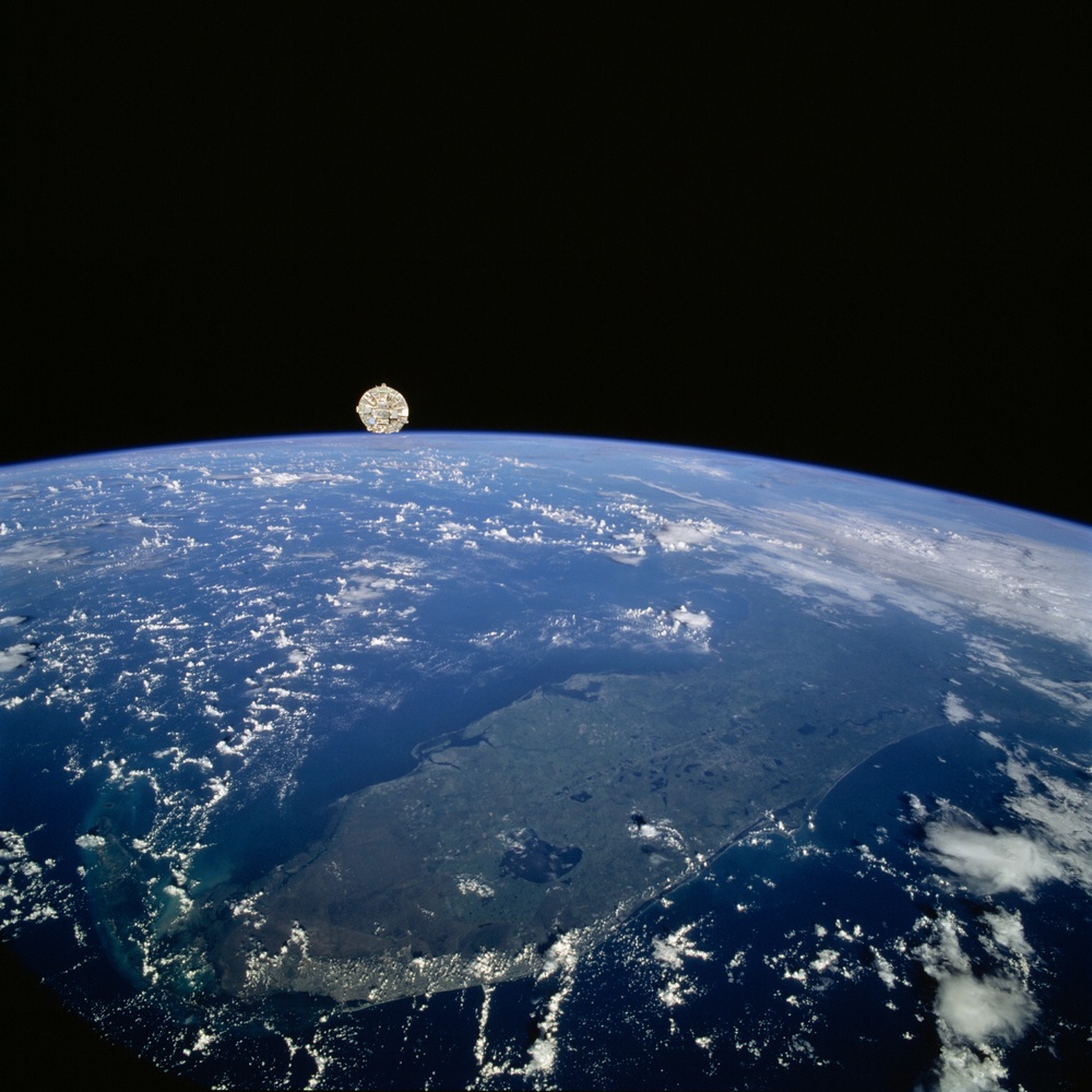 Wake Shield Facility in orbit above the Earth