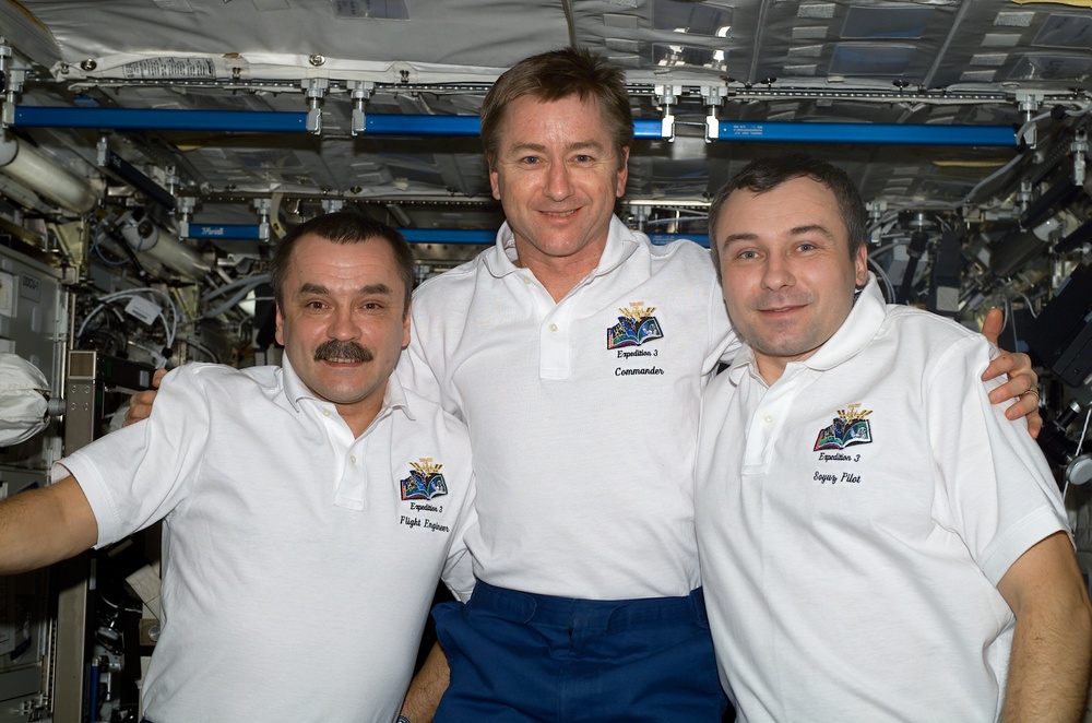 The Expedition Three crew poses for a portrait in the U.S. Laboratory