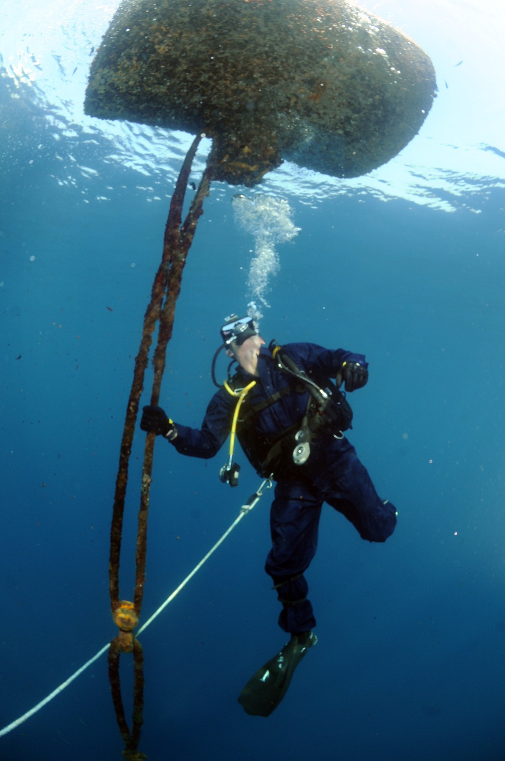 Navy diver surveys buoy