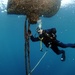 Navy diver surveys buoy