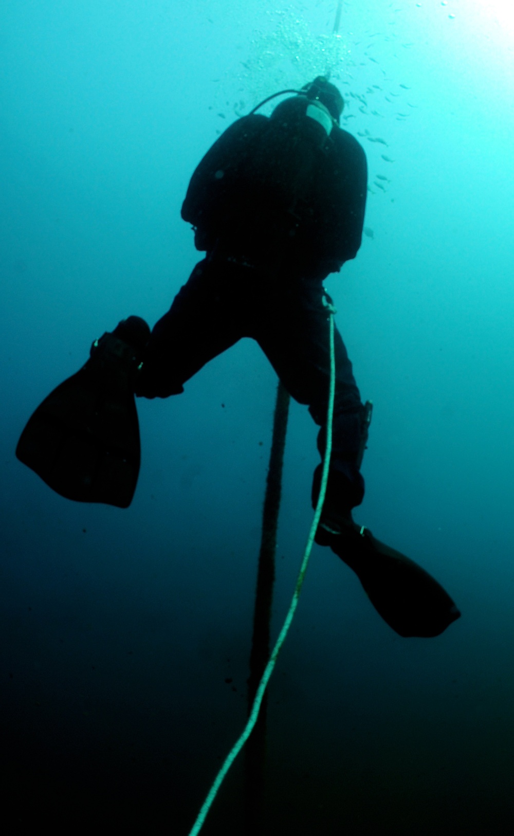 Navy diver surveys buoy