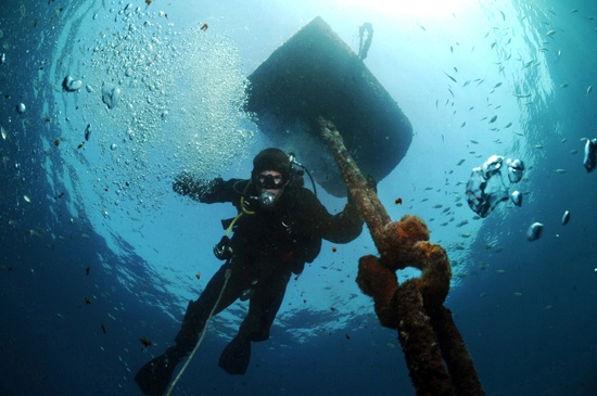 Navy diver surveys buoy