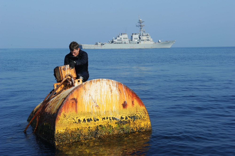 Navy diver surveys buoy