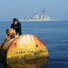 Navy diver surveys buoy