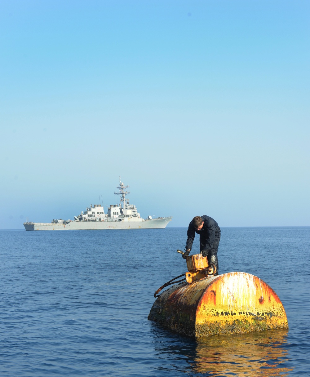 Navy diver surveys buoy