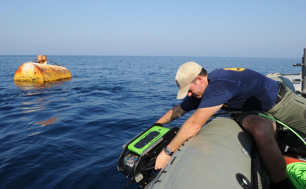 Navy diver surveys buoy