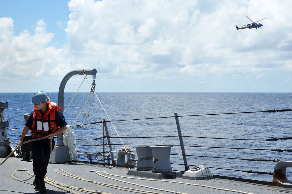 USS McCampbell sailor pulls line