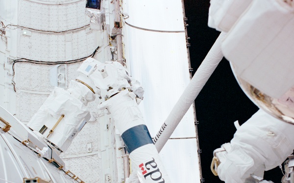 MS Parazynski secures the DCSU on Destiny with a PGT during the second EVA of STS-100