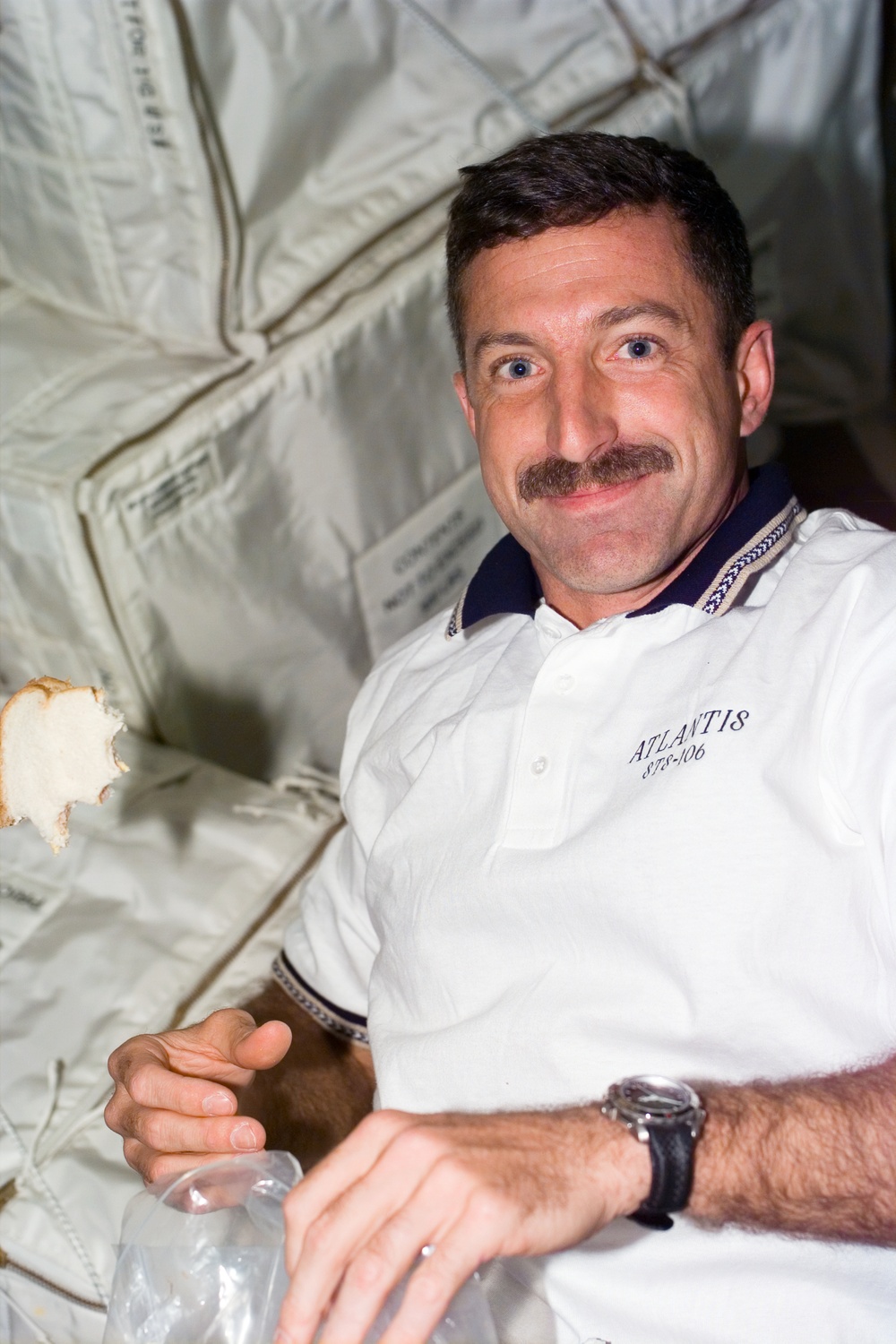 MS Dan Burbank eats a sandwich aboard Atlantis during STS-106