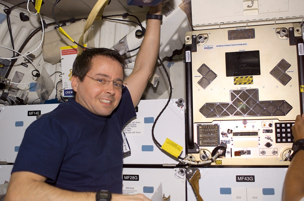 Bursch poses next to BPS installed in a slot on Endeavour's middeck for return on STS-111 UF-2