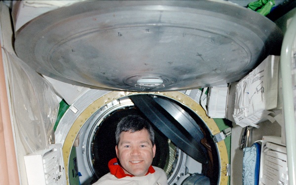 Pilot Frick poses in the Service Module during STS-110