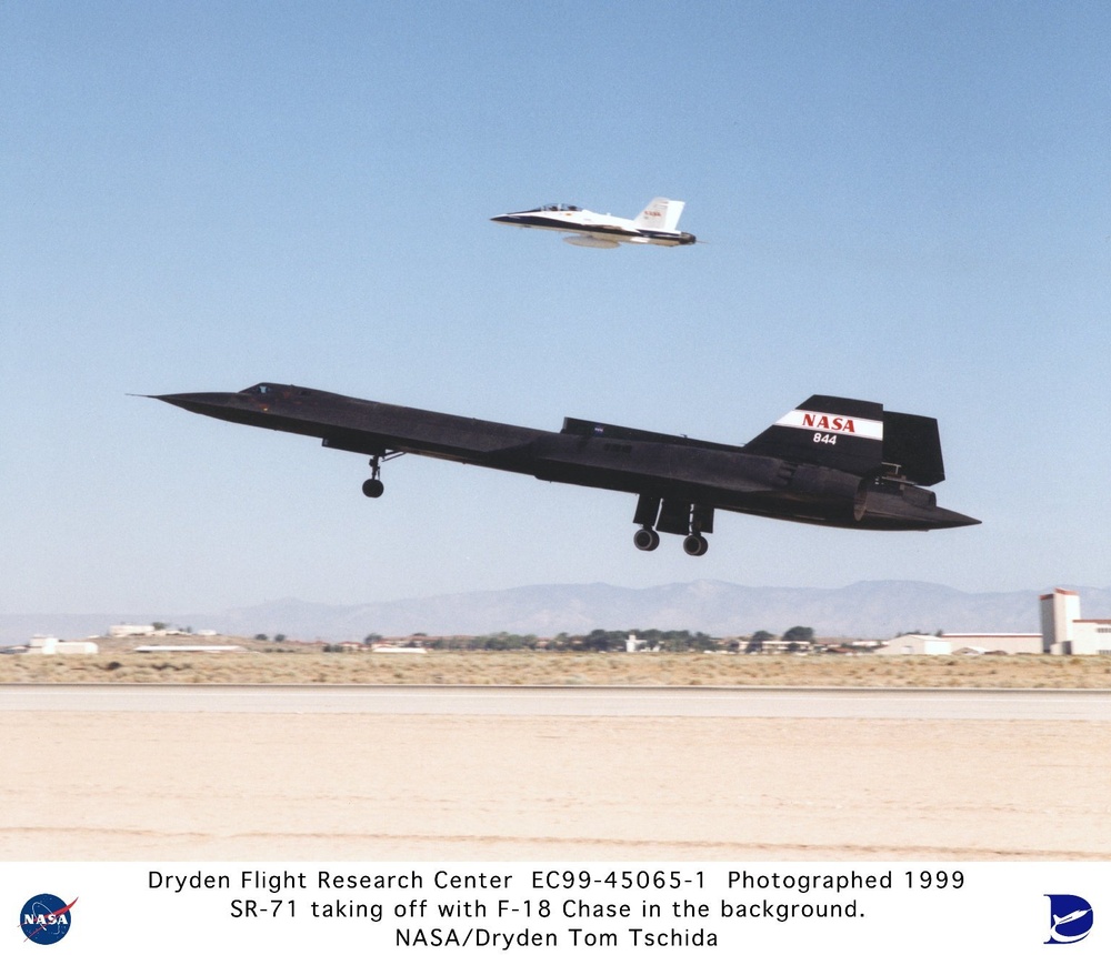 SR-71A Taking Off with Test Fixture Mounted Atop the Aft Section of the Aircraft and F-18 Chase Airc