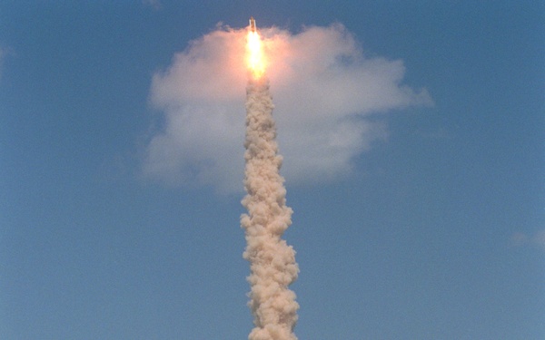 View of Endeavour climbing into the sky and breaking through a cloud during the STS-100 launch