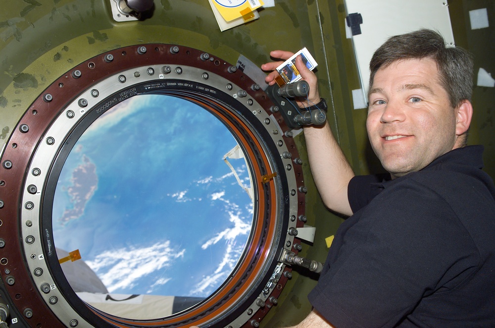 Pilot Frick looks out the nadir window of Destiny during STS-110's visit to the ISS