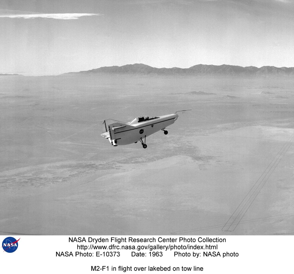 M2-F1 in flight over lakebed on tow line