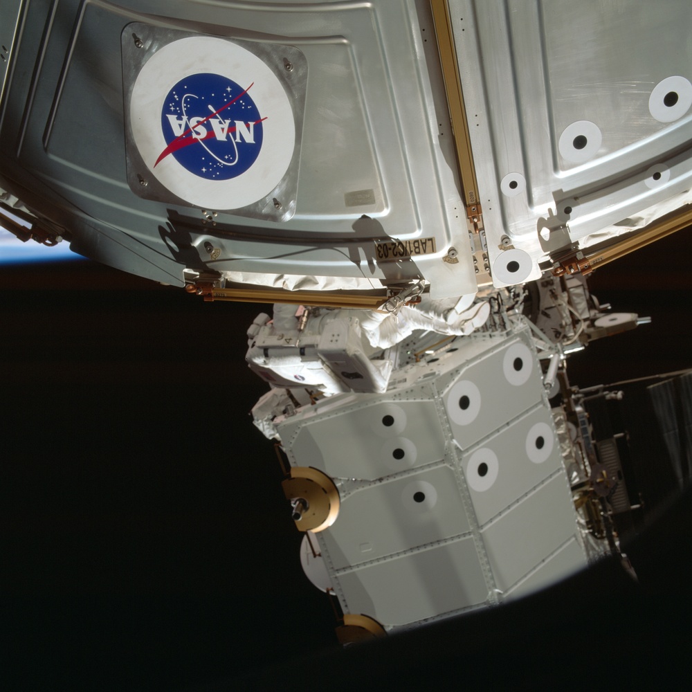 MS Parazynski works on the U.S. Laboratory during the first EVA for STS-100