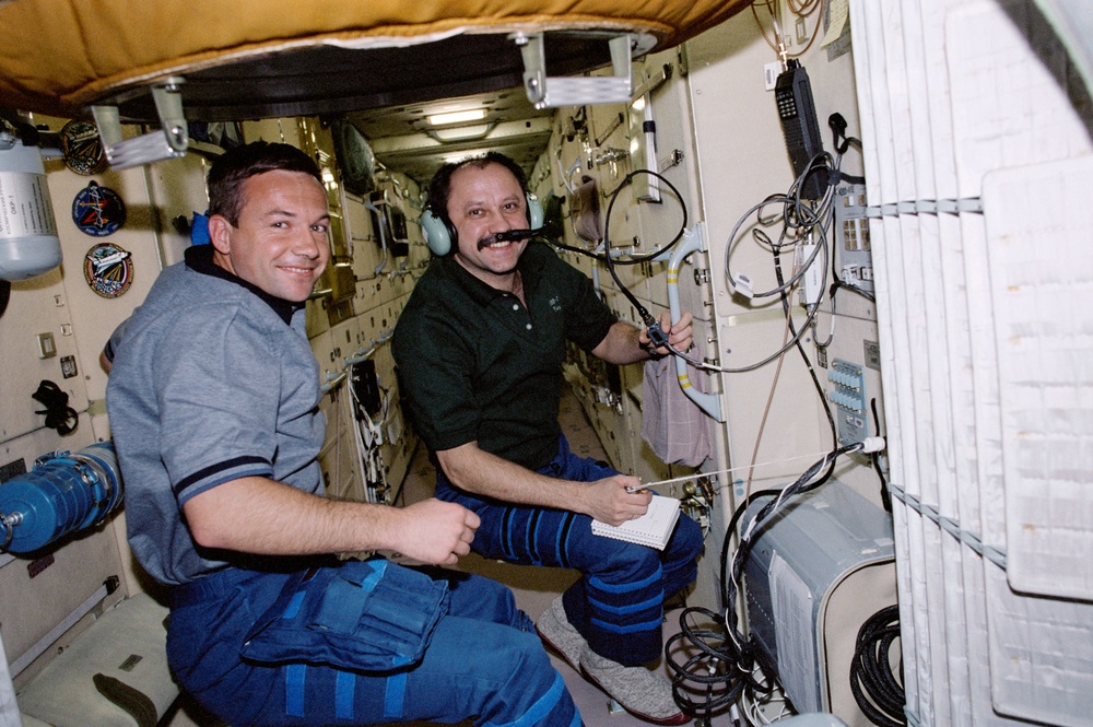 Usachev and Lonchakov use the HAM radio in Zarya during STS-100