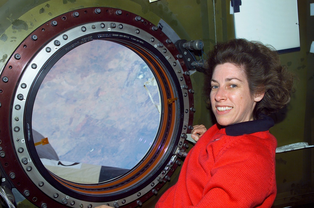 MS Ochoa looks out the nadir window of Destiny during STS-110's visit to the ISS