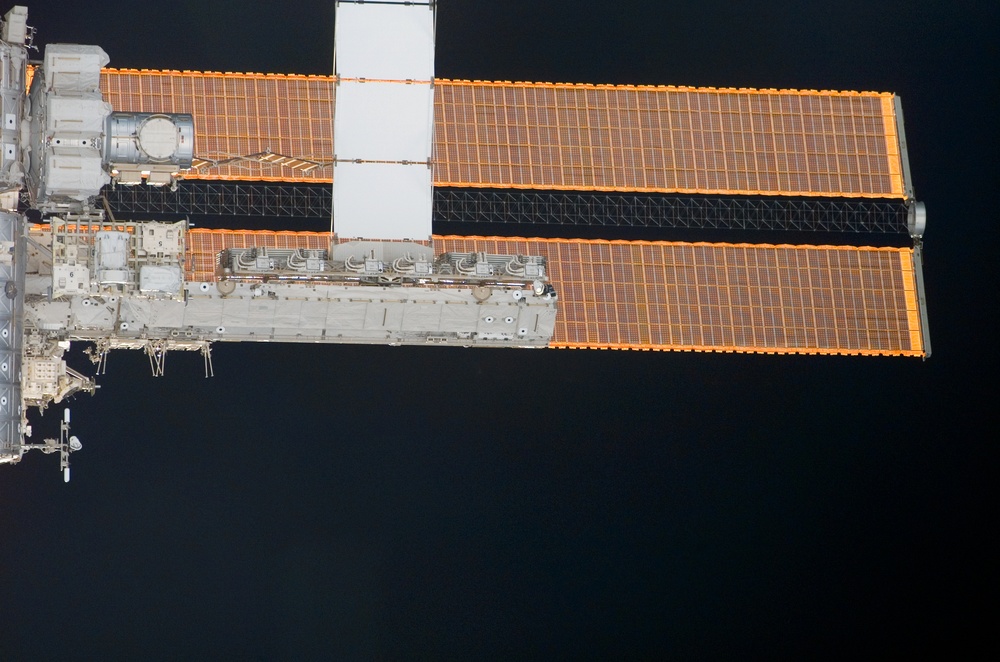 Nadar view of the Airlock and ITS S0 and P1 as the orbiter Discovery moves in for docking with the ISS during STS-121