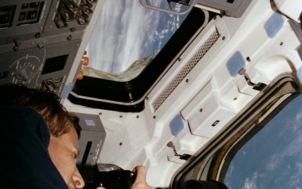 Crewmember in the aft flight deck with the HERCULES camera system.