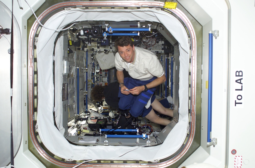 Pilot Ashby poses in the U.S. Laboratory during STS-100
