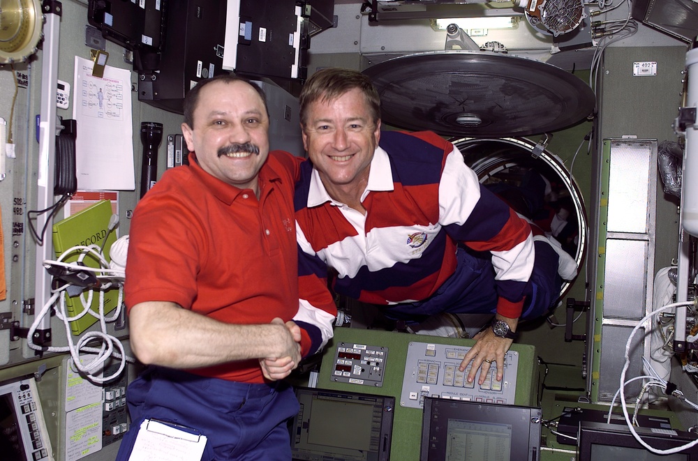 Usachev shakes Culbertson's hand in ISS Service Module/Zvezda module