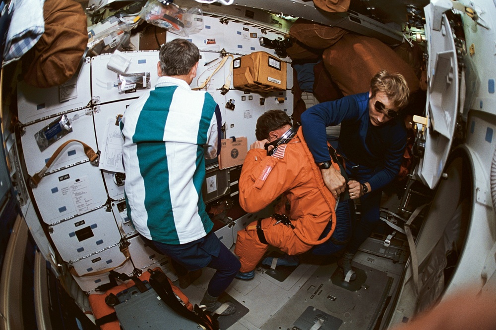MS Meade and PC Lee assist Pilot Hammond out of his space suit